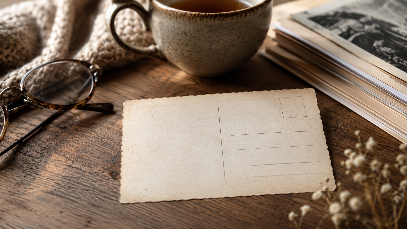 Eine Postkarte ohne Absender liegt neben einer Tasse Tee.